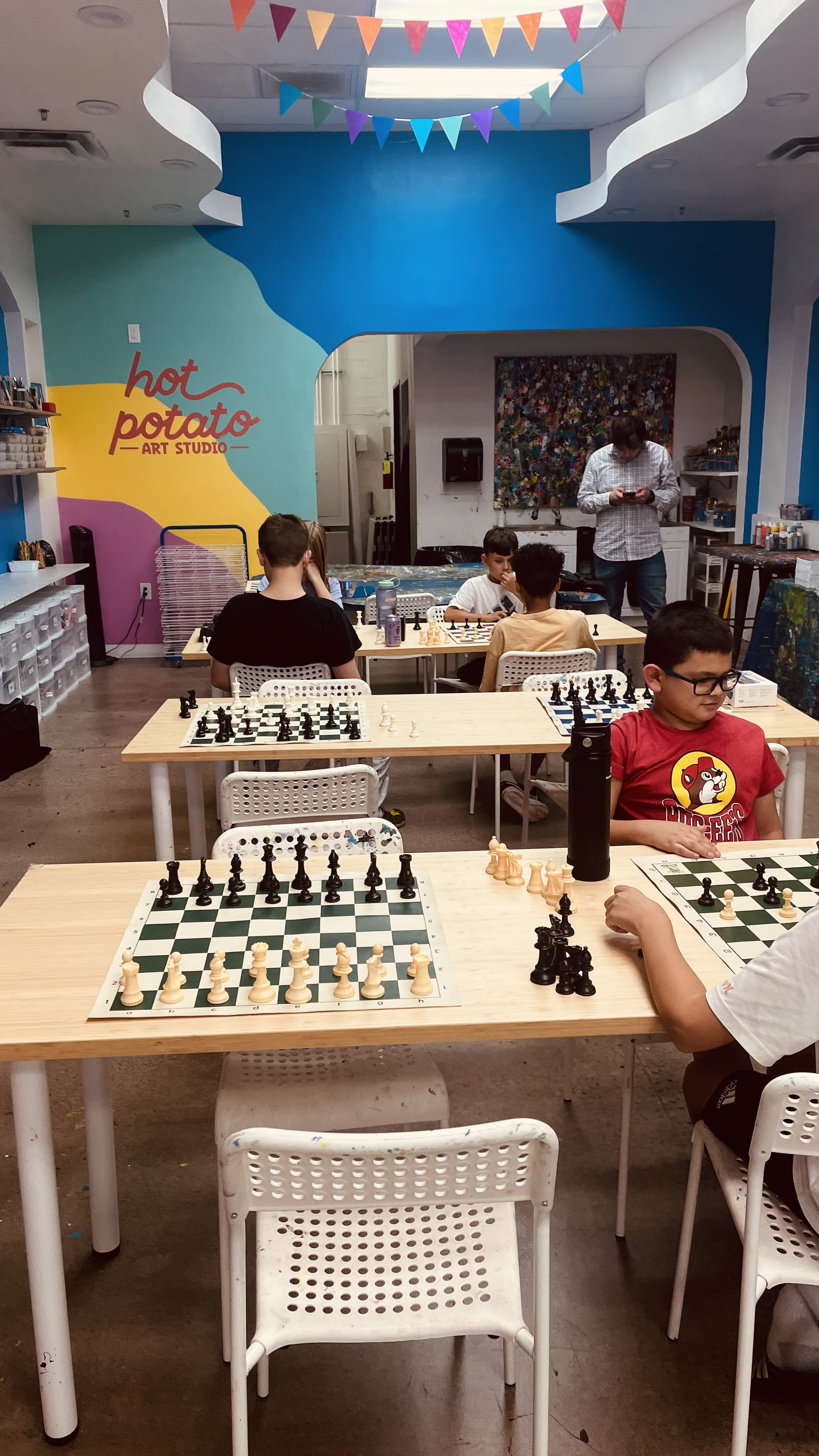 Chess boards set up inside Hot Potato Art Studio during a league session