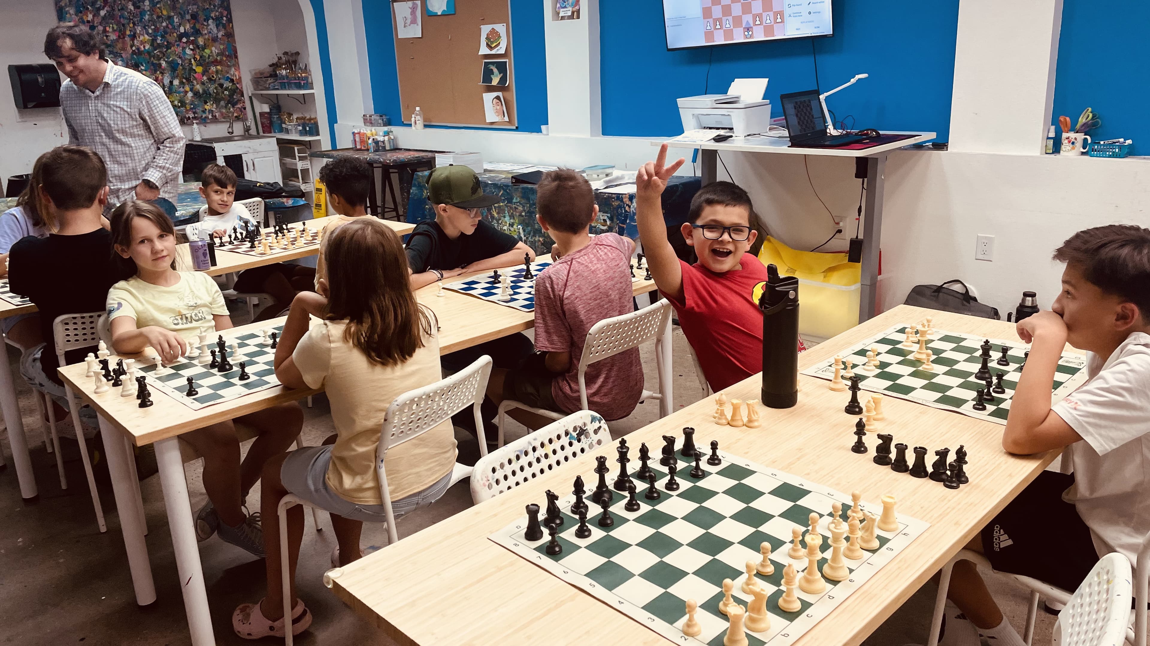 Students playing chess during a Next Move League session at Hot Potato Art Studio in Gilbert